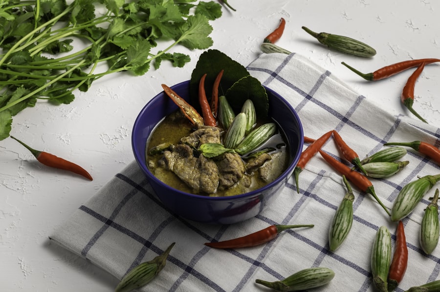 Bowl of Thai green curry with vegetables and herbs